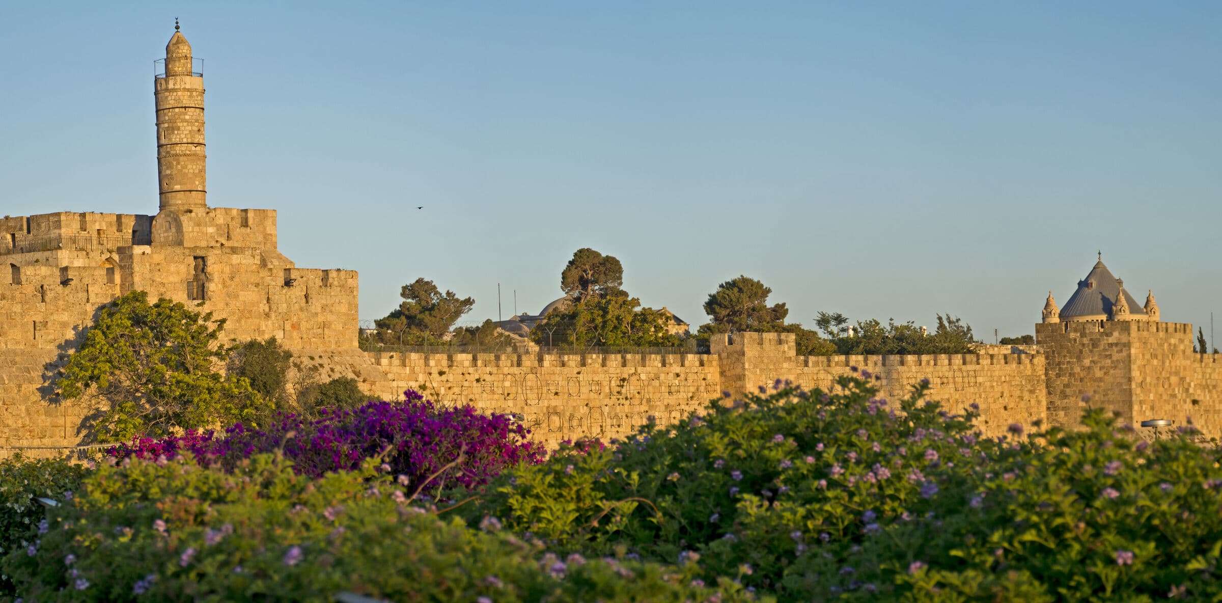 The walls of Jerusalem’s Old City and the Tower of David in golden evening light